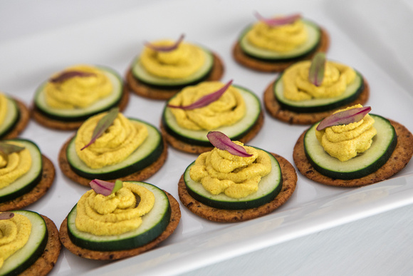 Gluten Free Cracker Rounds with Cucumbers Topped with Curry Turmeric Hummus